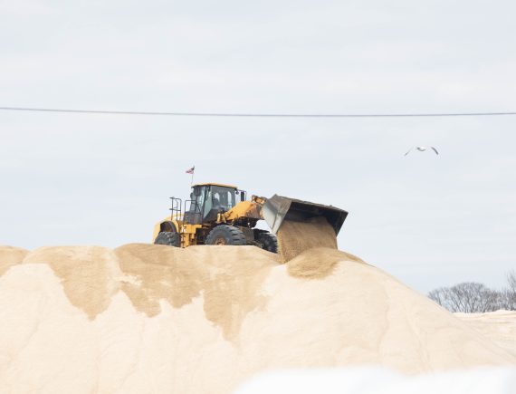 a front loader on a sand-pile